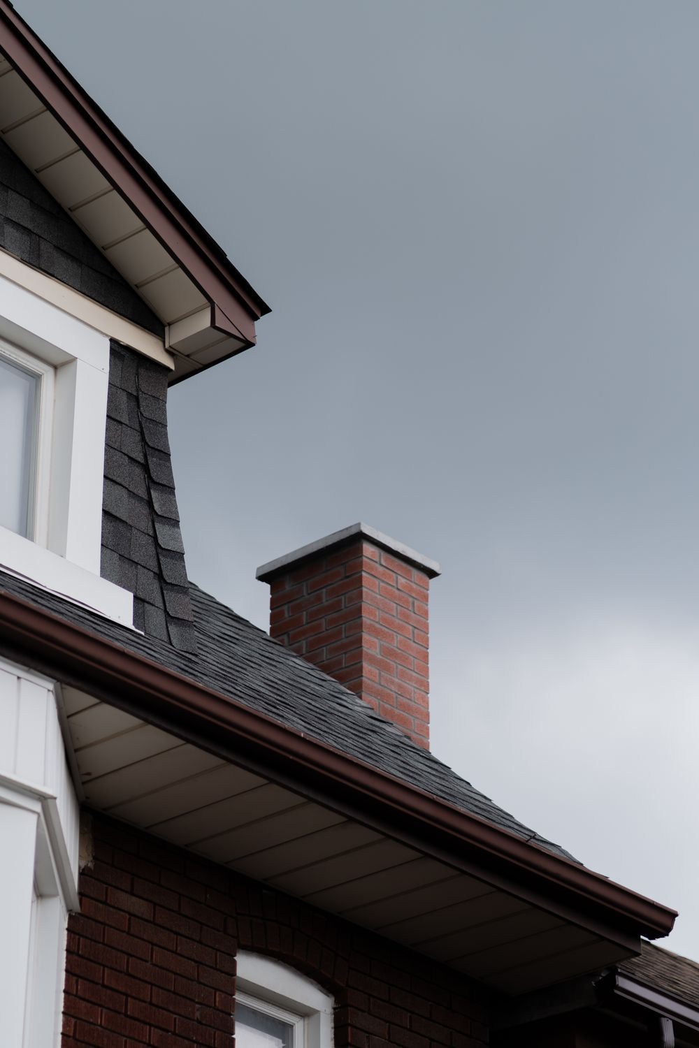 House with architectural asphalt shingles and a brick chimney